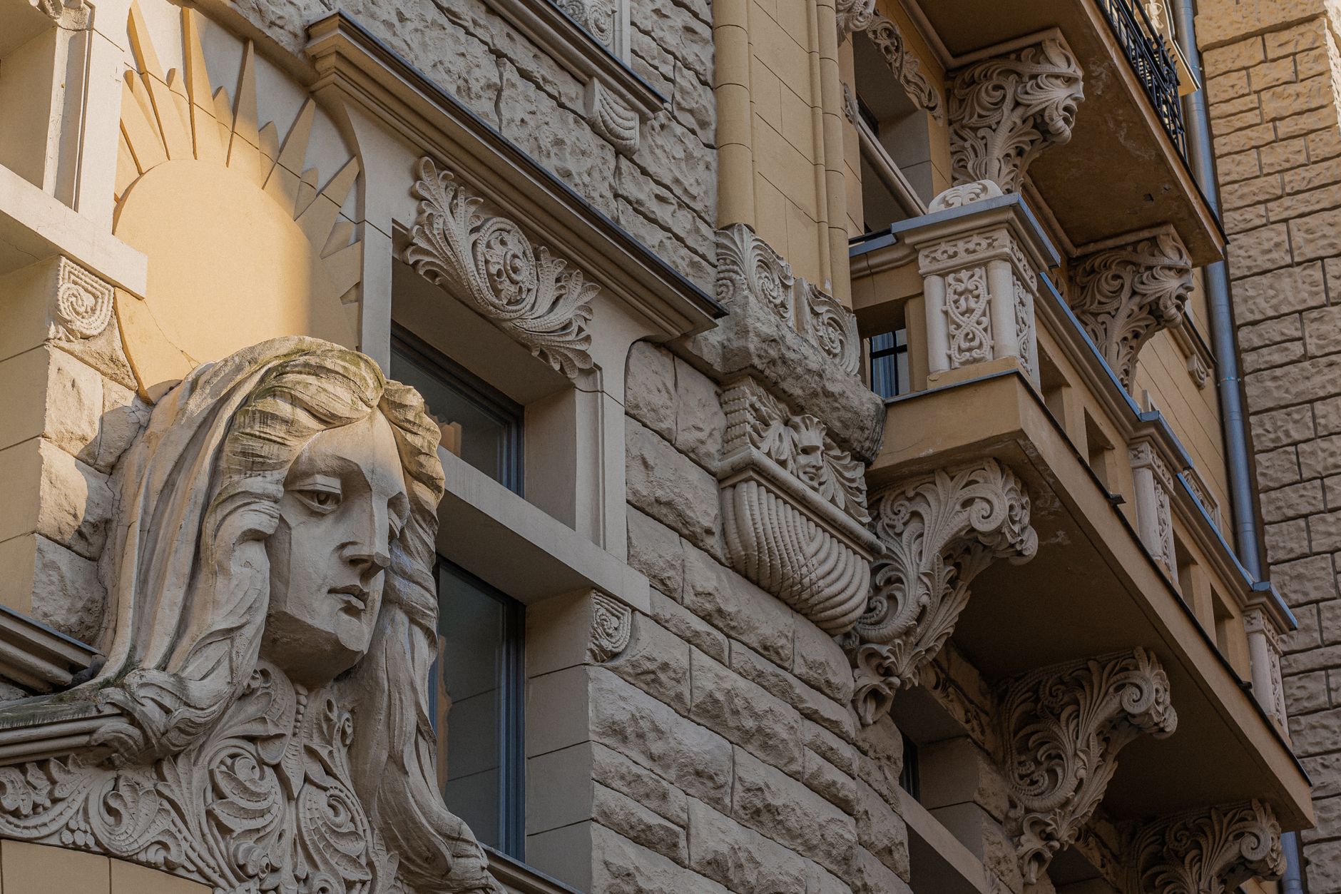 Close-up of an ornate Art Nouveau facade in Riga, featuring intricate carvings and sculptural decora