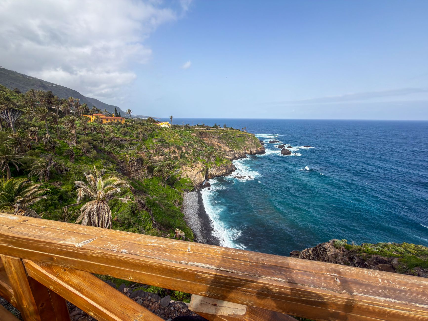 Dramatic coastal landscape with ocean and lush greenery in Tenerife, Canary Islands.